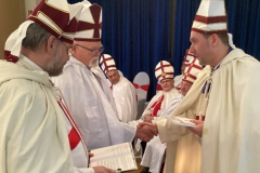 The High Priest, Andreas Riehl, congratulates Larry Painter following his admission to the Order. 